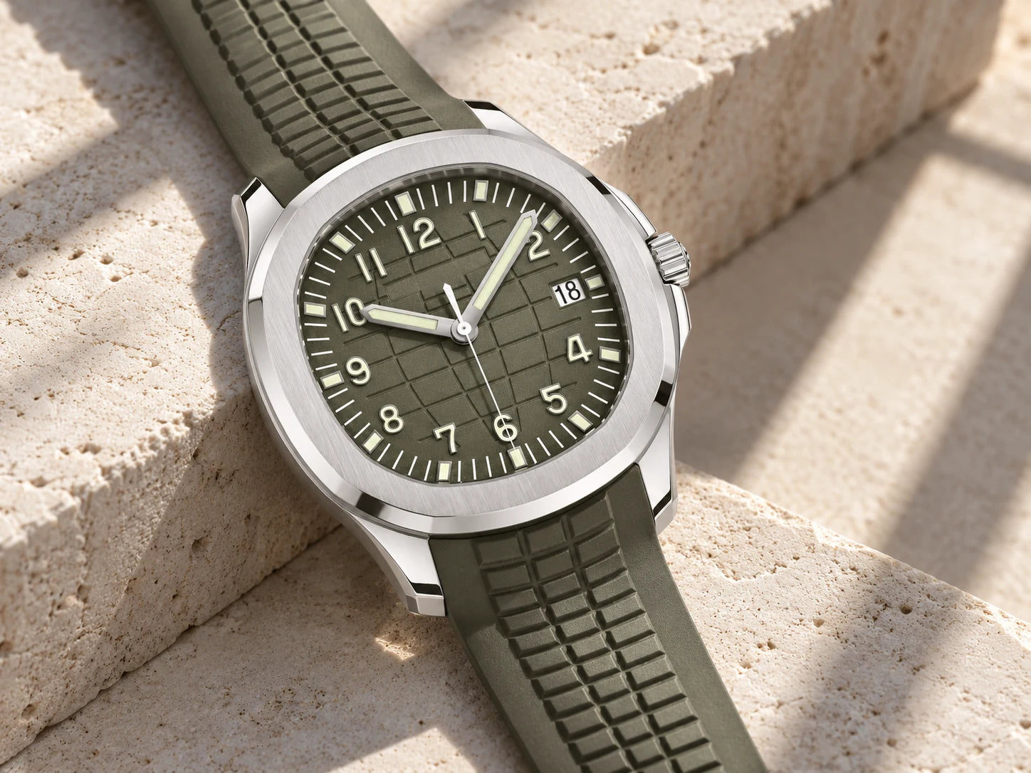 Olive watch on pale limestone, with a close view of the case and strap